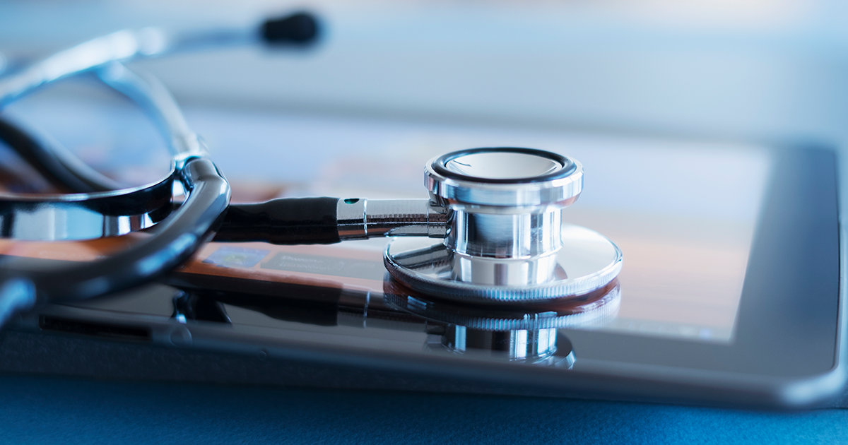 stethoscope on top of an iPad tablet computer