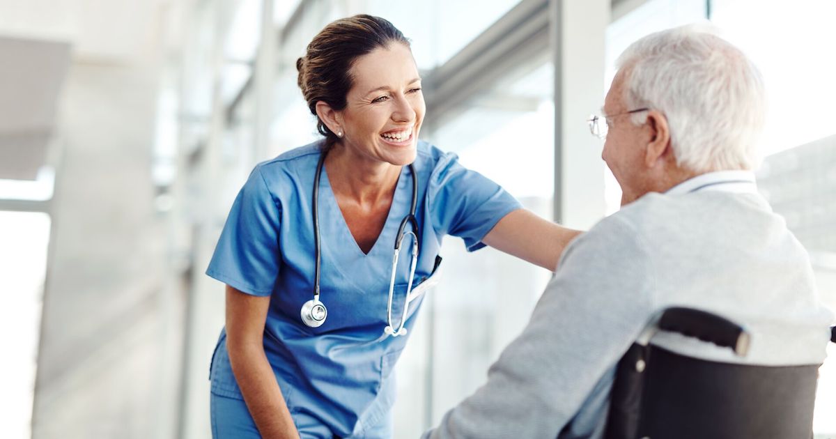 
  Person in a wheelchair next to a nurse
