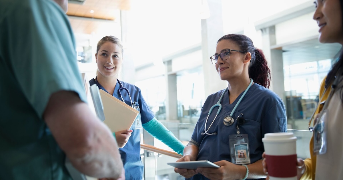 Clinical staff having a conversation in a hallway